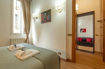 a bedroom with a bed with two towels on it at Frattina Cozy Flat Spanish Steps in Rome