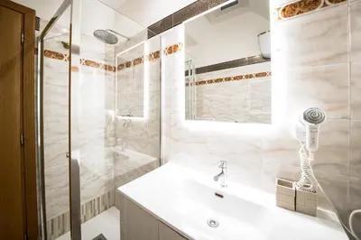 a white bathroom with a sink and a shower at Frattina Cozy Flat Spanish Steps in Rome