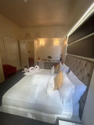 a bedroom with a large white bed with white pillows at Piazza Venezia appartamento con vista in Rome