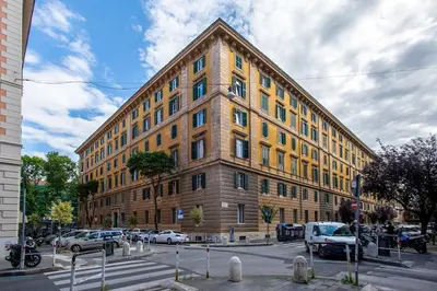 a large brick building with cars parked in front of it at Casa Mia in Rome