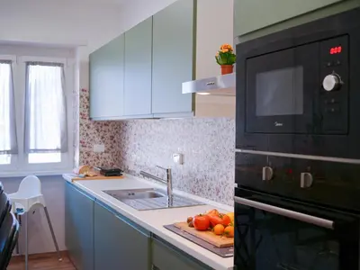 a kitchen with a sink and a microwave at La Casa dei Lettori in Rome