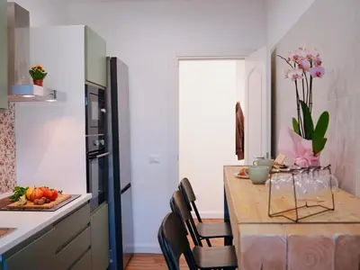 a kitchen with a table with chairs and a kitchen with a tableablish at La Casa dei Lettori in Rome