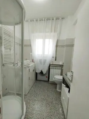 a bathroom with a shower and a toilet and a sink at Il Melograno - Just like at home! in Rome