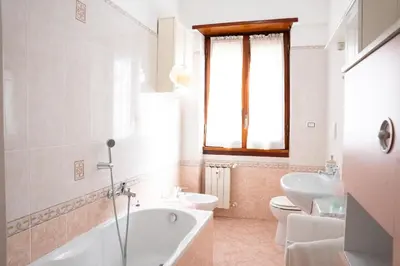 a dining room with a wooden table and chairs at Aurelio Apartment, Vatican Metro A in Rome