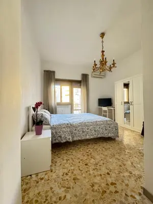 a bedroom with a bed and a chandelier at Ai Levii in Rome
