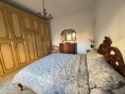 a bedroom with a bed and a dresser at Ai Levii in Rome
