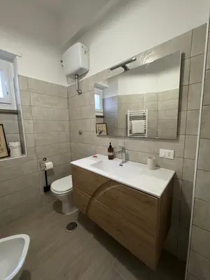 a bathroom with a sink and a toilet and a mirror at Ai Levii in Rome