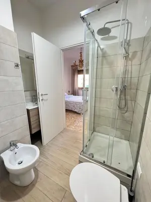 a bathroom with a shower and a toilet and a sink at Ai Levii in Rome