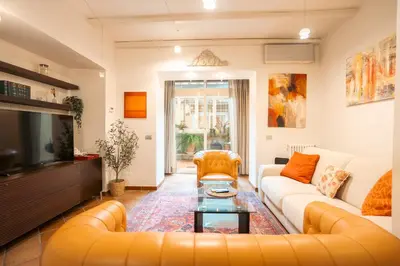 a living room with a couch and a tv at Casa Verde - Luxury apartment in Trastevere in Rome