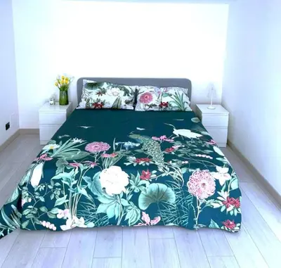a bed with a floral bedspread on top of it at Duplex Chic in zona trendy in Rome