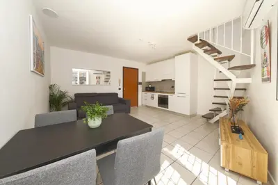 a dining room and living room with a table and chairs at Duplex Chic in zona trendy in Rome