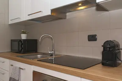 a kitchen counter with a sink and a microwave at Duplex Chic in zona trendy in Rome