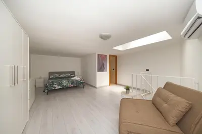 a living room with a couch and a bed at Duplex Chic in zona trendy in Rome