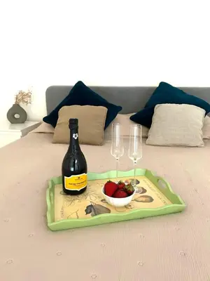 a tray with a bottle of wine and two glasses at Duplex Chic in zona trendy in Rome