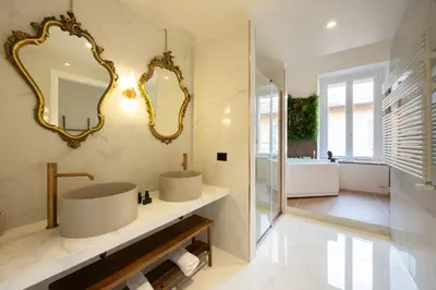 a bathroom with two sinks and a mirror at Casa Lilla in Rome