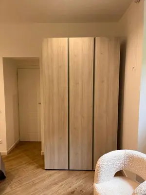 a large wooden cabinet in a room with a bed at Casa Vacanze Villa Barberina in Rome