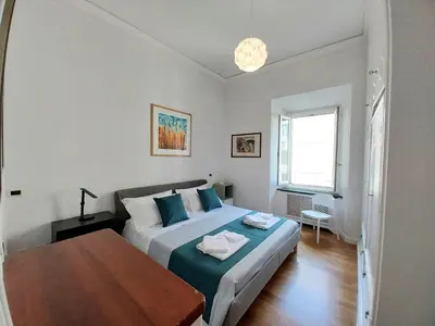 a bedroom with a bed and a table in it at A Casa di Vittoria in Rome