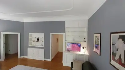 a living room with a tv on a wall at A Casa di Vittoria in Rome