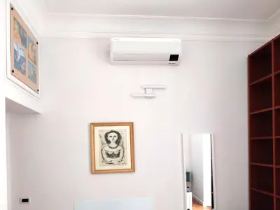 a ceiling fan in a room with a picture on the wall at A Casa di Vittoria in Rome