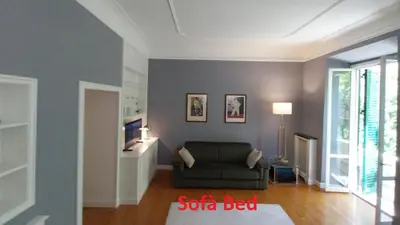 a living room with a couch and a tv at A Casa di Vittoria in Rome