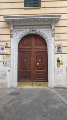 a large wooden door on the side of a building at A Casa di Vittoria in Rome