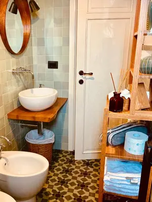 a bathroom with a white sink and a mirror at CasaNa' in Rome