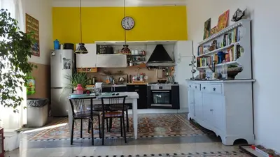 a kitchen with a table and a yellow wall at Casa Alessia a Roma in Rome