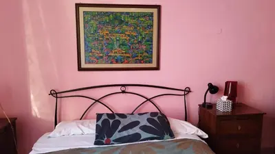 a bedroom with a bed and pictures on the wall at Casa Alessia a Roma in Rome