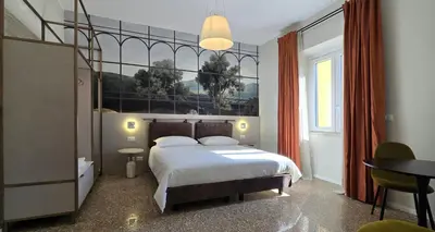 a bedroom with a bed and a table and a desk at Elegante Stanza Privata in Centro a Roma Colosseo - FLC Room in Rome in Rome