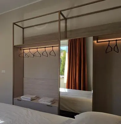 a large mirror in a bedroom with a bed at Elegante Stanza Privata in Centro a Roma Colosseo - FLC Room in Rome in Rome