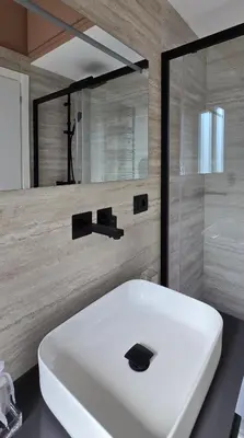 a white sink in a bathroom with a shower at Elegante Stanza Privata in Centro a Roma Colosseo - FLC Room in Rome in Rome