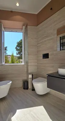 a bathroom with two sinks and a large window at Elegante Stanza Privata in Centro a Roma Colosseo - FLC Room in Rome in Rome