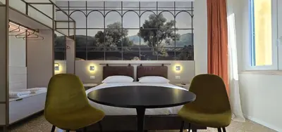 a bedroom with a bed and a table and chairs at Elegante Stanza Privata in Centro a Roma Colosseo - FLC Room in Rome in Rome