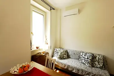 a living room with a couch and a table at P-House in Rome
