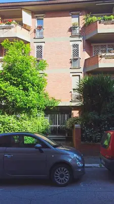 a silver car parked in front of a building at P-House in Rome