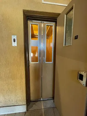 a wooden door in a room with a wall at Ostiense station penthouse in Rome