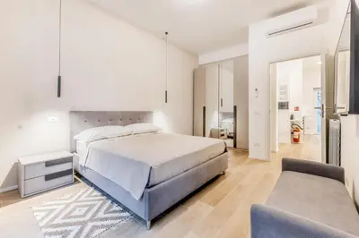 a bedroom with a large bed and a couch at Domus urbe San Paolo in Rome