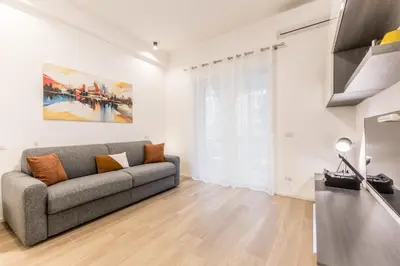 a living room with a couch and a kitchen at Domus urbe San Paolo in Rome