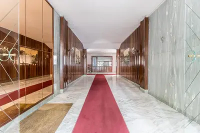 a corridor with a red carpet in a building at Domus urbe San Paolo in Rome
