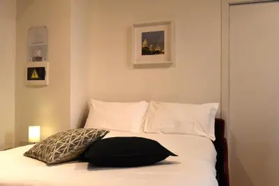 a bed with a black pillow on top of it at LG Apartment - Near Vatican City, Rome in Rome