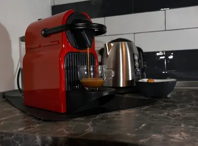 a red mixer sitting on a kitchen counter with a drink at LG Apartment - Near Vatican City, Rome in Rome