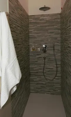 a bathroom with a shower with a shower head at LG Apartment - Near Vatican City, Rome in Rome