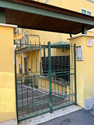 a gate in front of a building with a balcony at LG Apartment - Near Vatican City, Rome in Rome