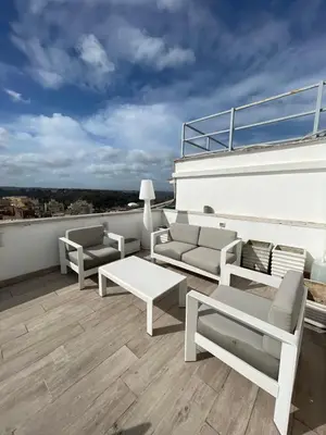 a patio with couches and tables on a roof at YCH-Attico con splendida vista su Villa Ada in Rome