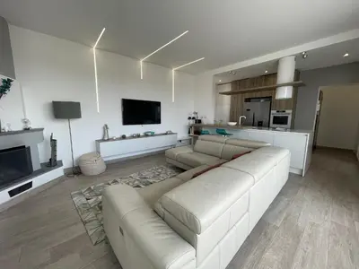 a white living room with a couch and a tv at YCH-Attico con splendida vista su Villa Ada in Rome