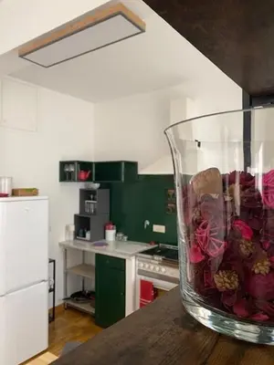 a vase filled with flowers sitting on a counter in a kitchen at Civico 18 in Rome