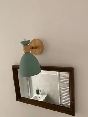 a bathroom mirror with a sink and a lamp at Civico 18 in Rome