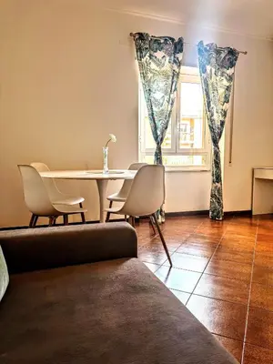 a living room with a table and chairs and a window at ValGa Suite near Vaticano and Centre in Rome