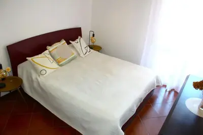 a bedroom with a bed with white sheets and pillows at ValGa Suite near Vaticano and Centre in Rome