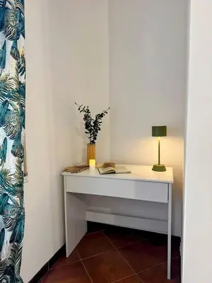 a white desk with a lamp and a plant on it at ValGa Suite near Vaticano and Centre in Rome